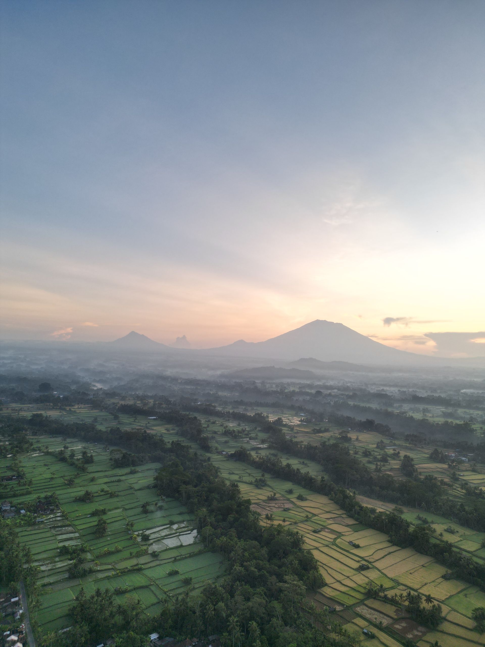 Drone shot flying over a mountain valley at sunrise